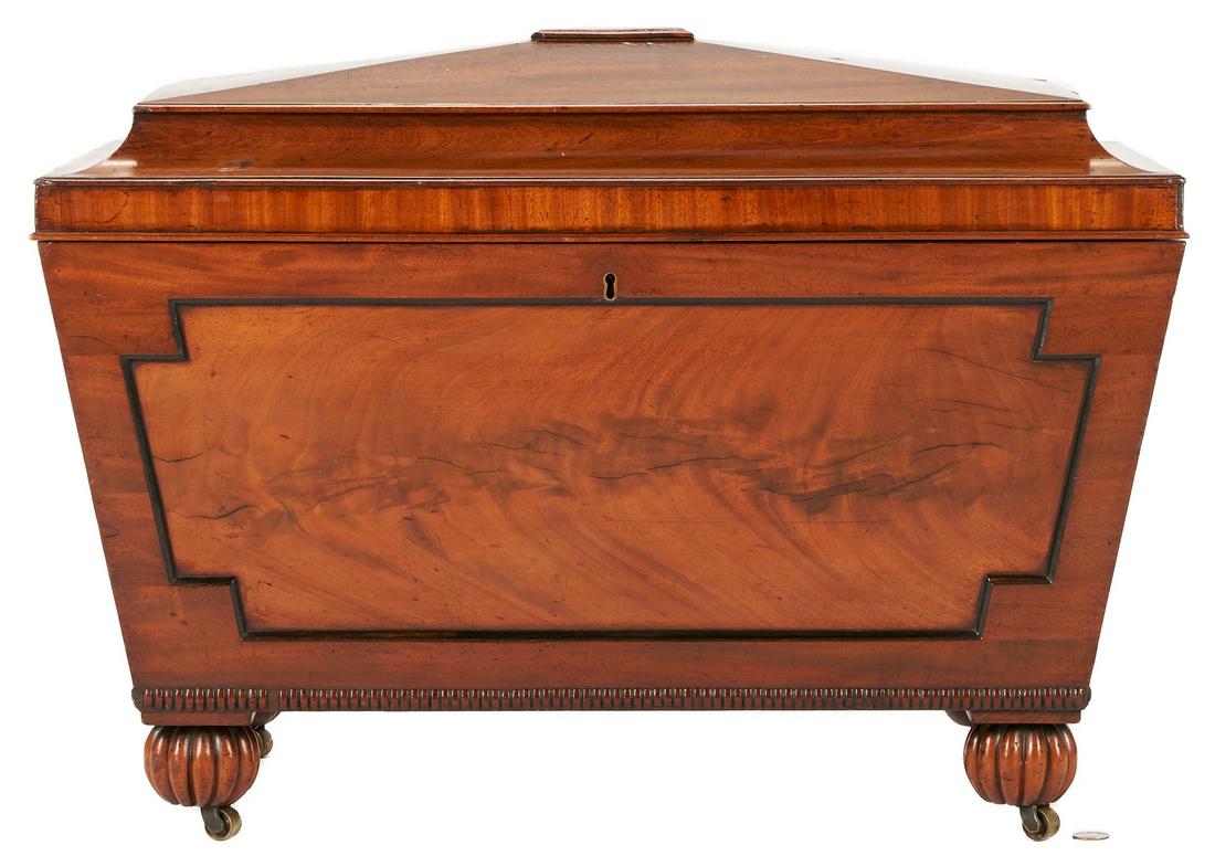 English Regency Style Sarcophagus Cellarette: English Regency style mahogany sarcophagus form cellarette or wine cooler with inset front panel having ebonized trim, lead-lined interior, reeded lower edge, and reeded bulbous bun feet. 21 3/4" H x 