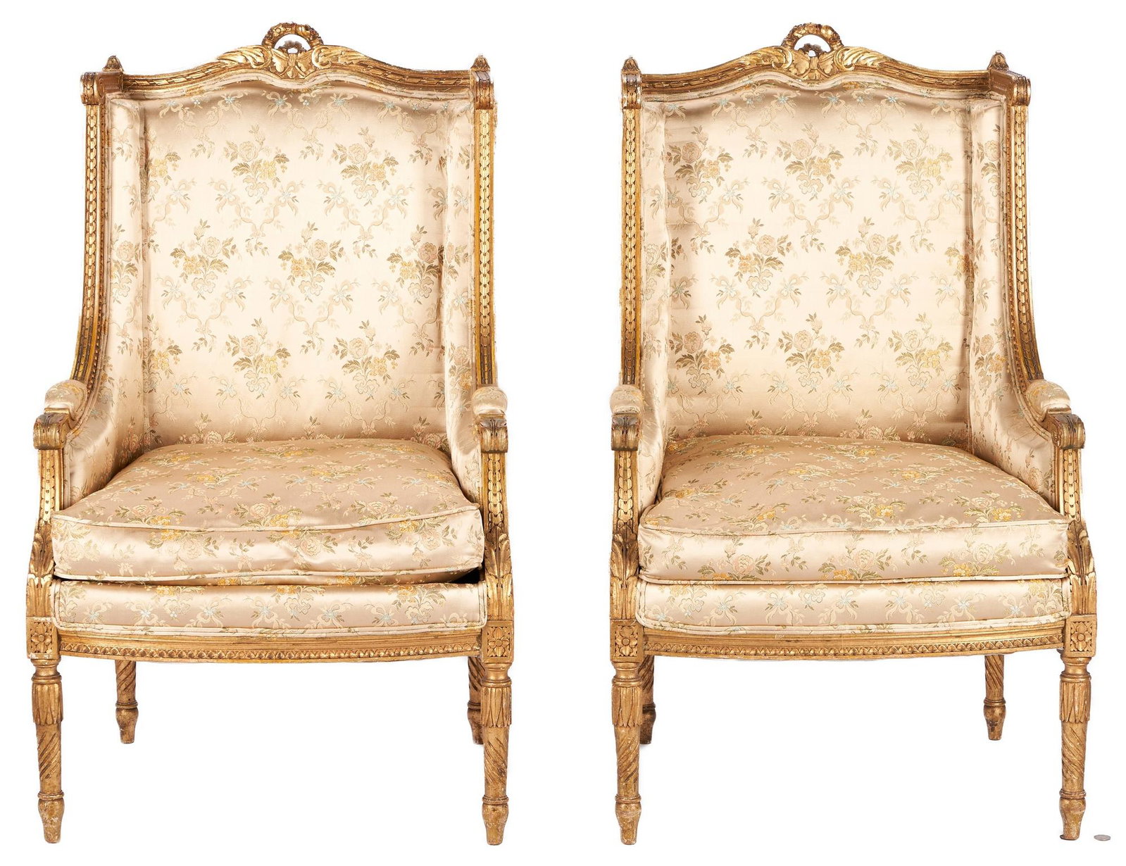 Pair Louis XVI Style Giltwood Armchairs: Pair of two (2) French gilt carved Louis XVI style fauteuils or armchairs, squared backs having shaped and carved wreath, ribbon, and floral crests; fluted finials; acanthus, guilloche, and beaded car