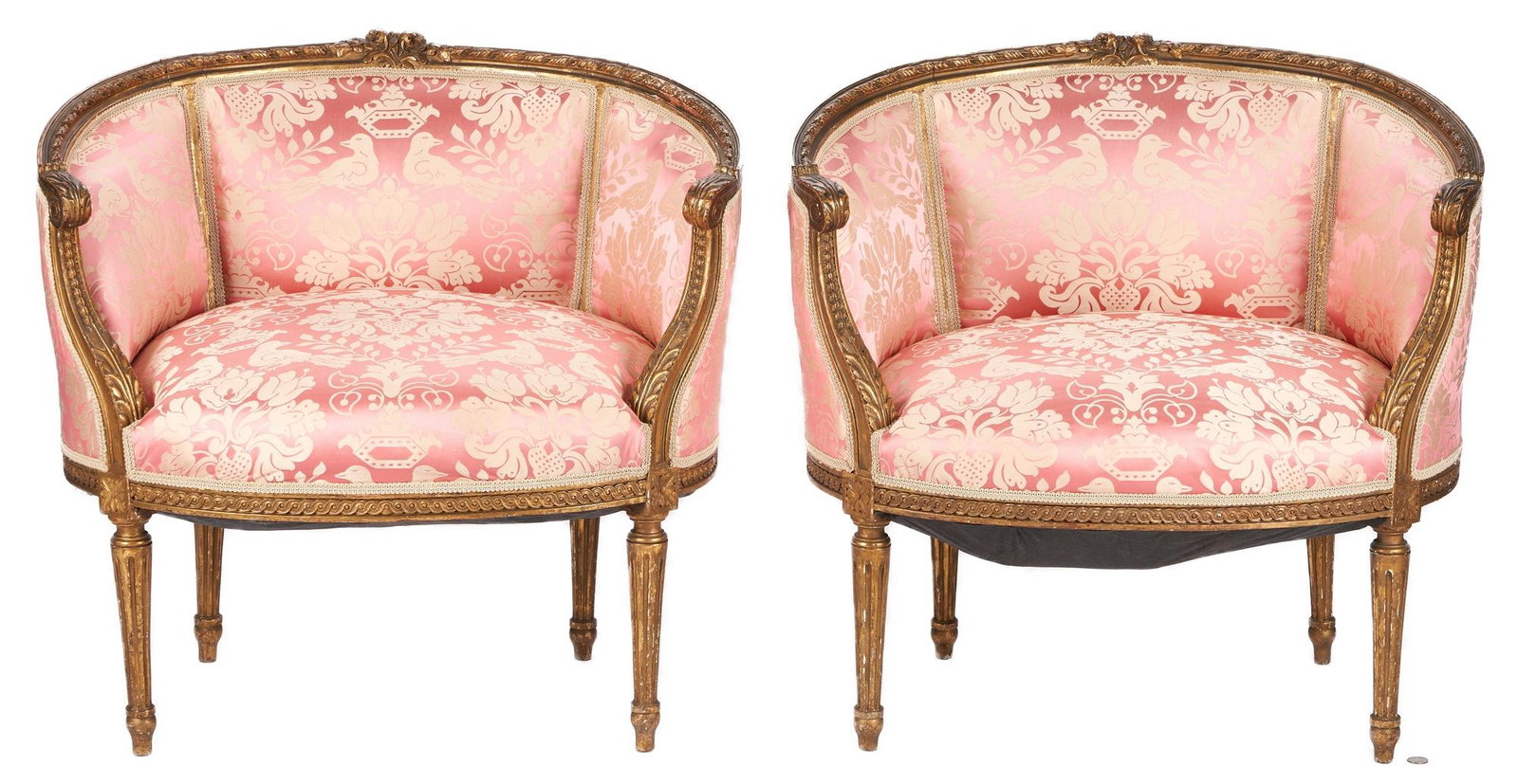 Pair French Louis XVI Style Giltwood Tub Style Armchairs: Pair of two (2) carved giltwood French Louis XVI style tub chairs with ribbon-carved frames crested with flowers, acanthus carved curved arms, a tripartite upholstered back, upholstered seats with rai