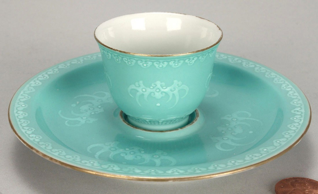 Chinese Porcelain Sake Cup and Saucer: Chinese porcelain sake cup and saucer with robin's egg blue glaze and raised bat decoration. Cup - 1 1/2" H. Saucer - 4 3/4" dia. 20th century.