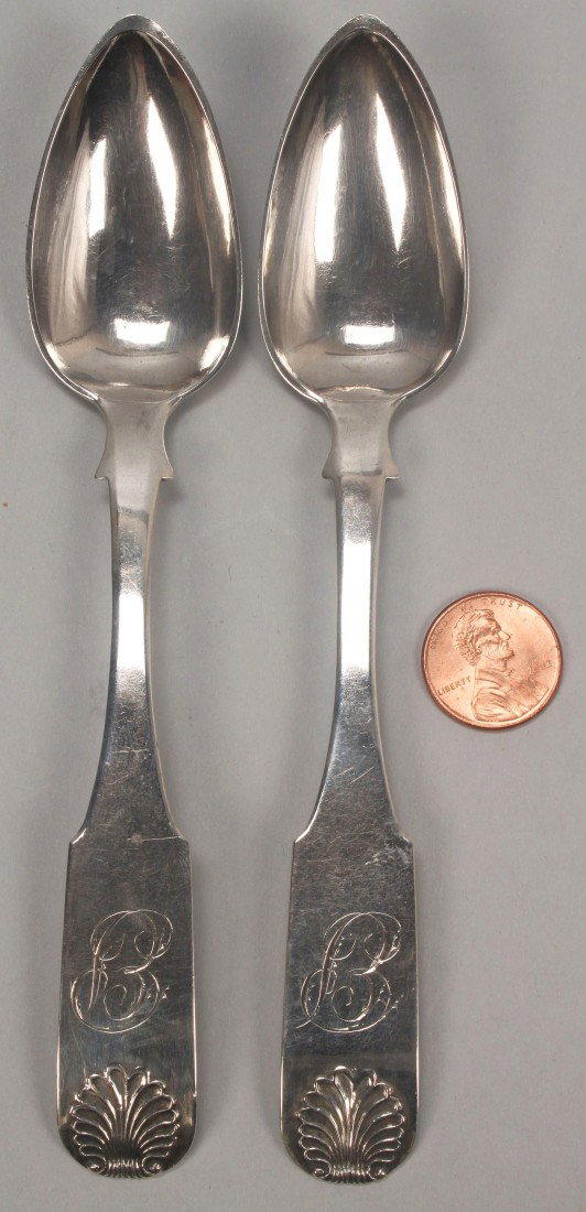 Two Charleston SC coin silver spoons: Two coin silver teaspoons with shell pattern on the handles and backs of bowls, each marked Dumoutet in a banner John B. Dumoutet, working Philadelphia, Pennsylvania, 1793-1801, and Charleston, South 