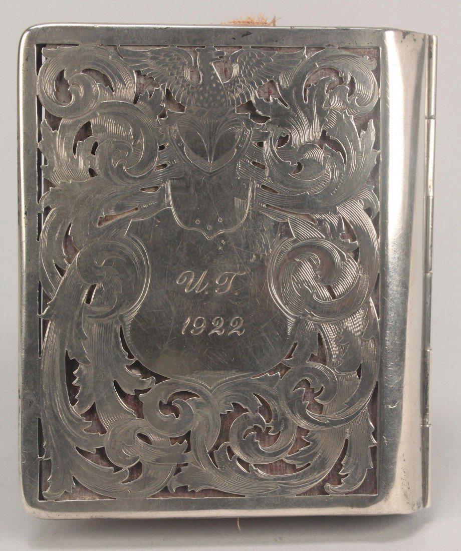 Sterling Silver Case, University of Tennessee: Sterling silver card case with central cartouche and pierced foliate and eagle designs to both sides. Lined with red leather and bindings to house playing cards and calling cards. Marks for R. Blackin
