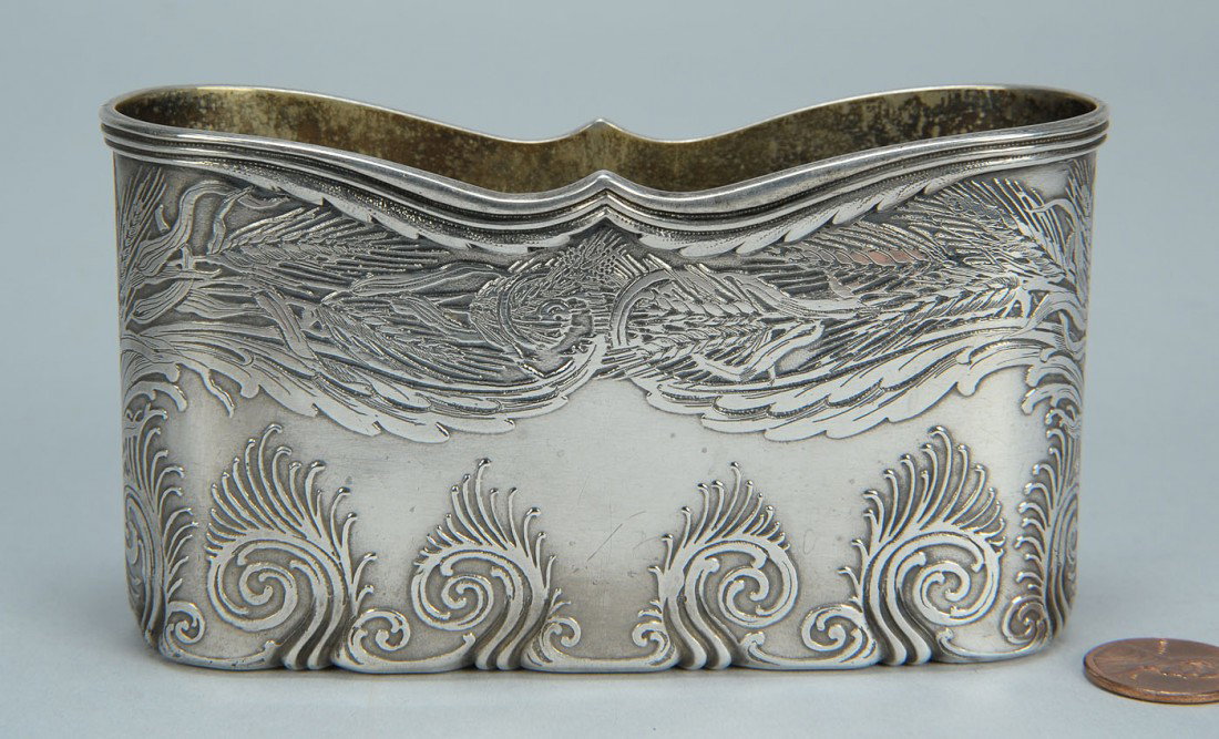 Tiffany sterling holder, Columbian Exposition: Tiffany sterling silver letter or flask holder, undulating top edge over a chased wheat design, the lower edge with a repousse scroll and tendril design, possibly the Vine-Wheat pattern. Marked on bas