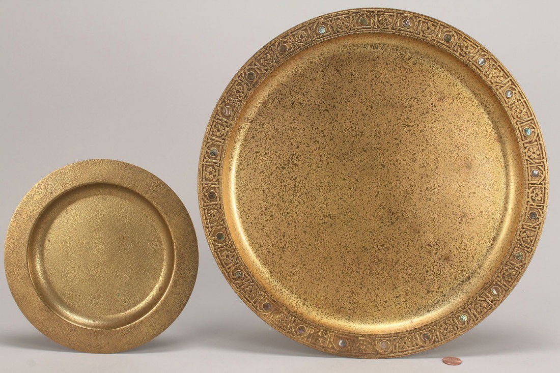 Tiffany Studios gilt-bronze plate and charger: 1ST ITEM: Tiffany Studios gilt-bronze charger with abalone inlay, impressed mark on bottom: "Tiffany Studios / New York / 1728." 14" dia, 2ND ITEM: Tiffany Studios gilt-bronze plate, impressed mark on