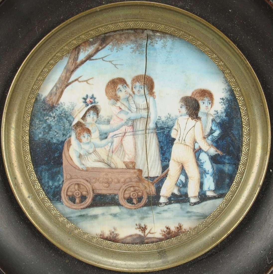 Miniature painting, children in wagon: Miniature watercolor on ivory portrait of six children, two being pulled in a wagon with two of the boys acting as horses, landscape background. Housed in a square ebonized wood frame with round openi