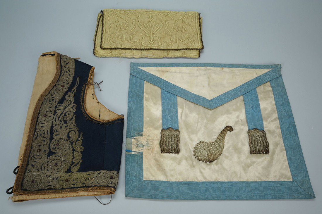 19th c. Vest, Silk Purse and Silk Panel: Item 1: Blue woolen vest with elaborate passementerie decoration, partially lined in a red toile. Probably European, 19th century. 14" H x 32" W (circumference). Item 2: Early silk hand embroidered pu