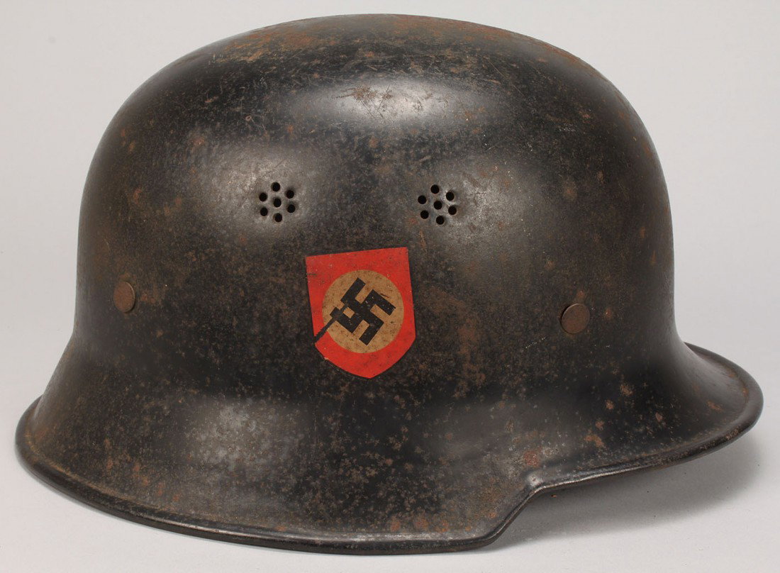 German WW II M34 Police/Fireman Helmet: German WWII M34 police/fireman helmet with two decals, red shield with white circle and black swastika and a black decal with a silver wreath and police eagle. Tan leather liner and black leather chin