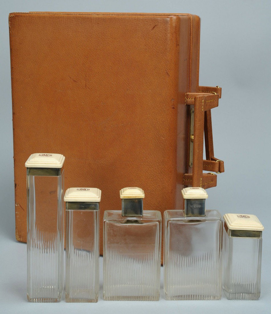 Asprey, London Partial Men's Toiletry Set: Asprey sterling and ivory mounted partial toiletry set, beige leather case retaining 5 original bottles w/ sterling and ivory caps. Monogrammed JMD. 13-1/4" L x 5-1/4" D.1st half 20th century. Provena