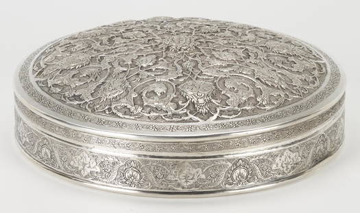 Southeast Asian Repousse Silver Box: Southeast Asian silver betel box, XRF tests 90% silver, round covered form, the lid with repousse undulating dragon, foliate and vine decoration within an engraved foliate border and the sides with en