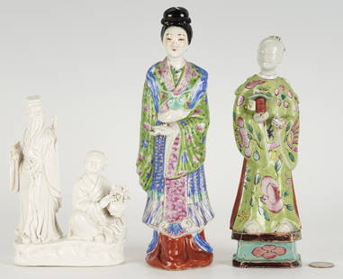 3 Chinese Porcelain Figures, Polychrome and Blanc De Chine: 1st item: Chinese polychrome earthenware standing figure of a male immortal depicted in traditional robed clothing with foliate decoration, holding an object in one hand and standing on a blue-tiered