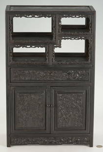 Asian Hardwood Miniature Cabinet: Asian hardwood miniature display cabinet, likely Chinese, with four display shelves at the top, one long central drawer and two lower doors, all resting on a bracket feet base. Carving throughout