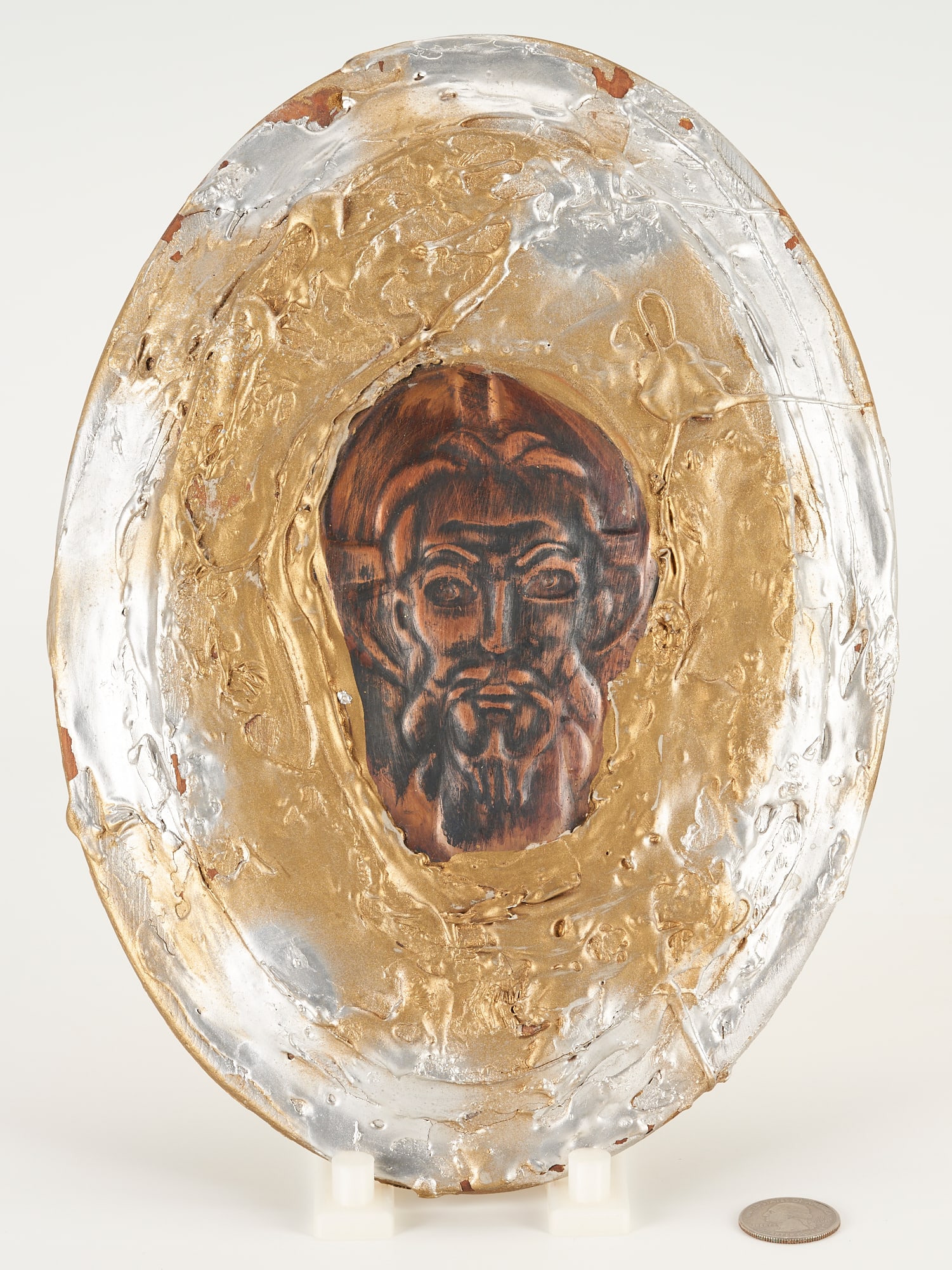 Greg Ridley Mixed Media Plaque, Christ: Gregory D. Ridley (American/Tennessee, 1925-2004), "Christ," mixed media oval plaque with inset copper panel depicting the face of Christ, surrounded by thick applications of silver and gold metallic