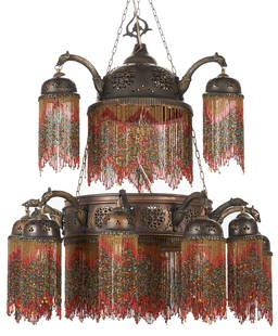 Moroccan Style Pierced Copper and Beaded Chandelier #2, ex - Naomi Judd: Moroccan style pierced copper and beaded chandelier. Hammered and pierced copper frame in two graduated tier with thirteen arms and 15-lights. Domed pierced brass shades suspended from eagle head form