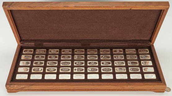 50 Silver Ingots, The Franklin Mint, 104 Oz Troy: Box of 50 sterling silver ingots representing different state banks in 1973, within a stock walnut wooden box with brown velvet fitted interior accommodating each ingot. Each rectangular ingot weighin