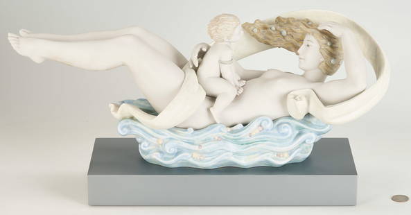 Lladro Porcelain Sculpture, The Flow of Life: Limited edition Lladro porcelain sculpture titled "The Flow of Life" designed by Jose Javier Malavia, released in 2006 and retired in 2015. Depicts a reclining mother figure resting on a blue wave bas