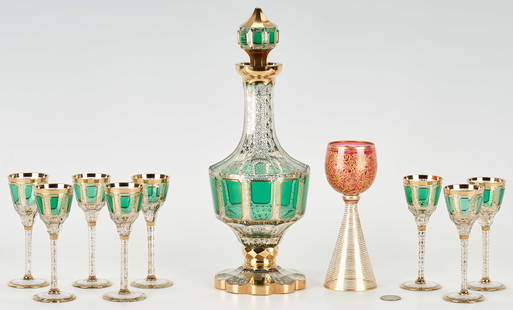 Moser Style Bohemian Green Glass Cabochon Decanter Set + 1 Goblet: Moser style Bohemian Glass Decanter set comprising eight (8) cordials and a decanter, each with clear crystal body and cut emerald cabochons decorated with gilt foliate and banding, plus one (1) addit