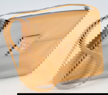 Vintage Chanel Tan Pebble Leather Shoulder Bag: Vintage Chanel single flip top shoulder bag in tan pebble leather, bag and shoulder strap polished gold plated "CC" metal logo. Tan leather divided interior, zippered pocket, stamped "Chanel / (copyri