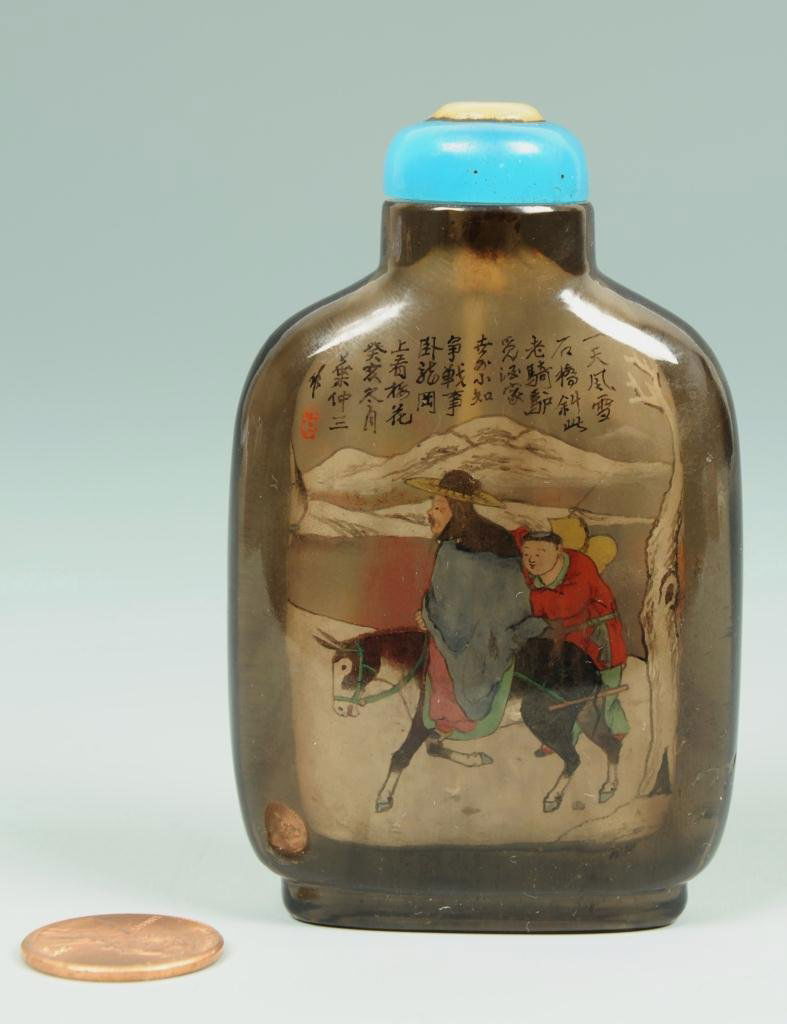 Chinese interior painted quartz snuff bottle: Smoky quartz snuff bottle, the interior signed and finely painted with figures, donkey and horse from Chinese literature, with a pearl and lapis-like stone stopper and ivory spoon. 3"H. Chinese, late