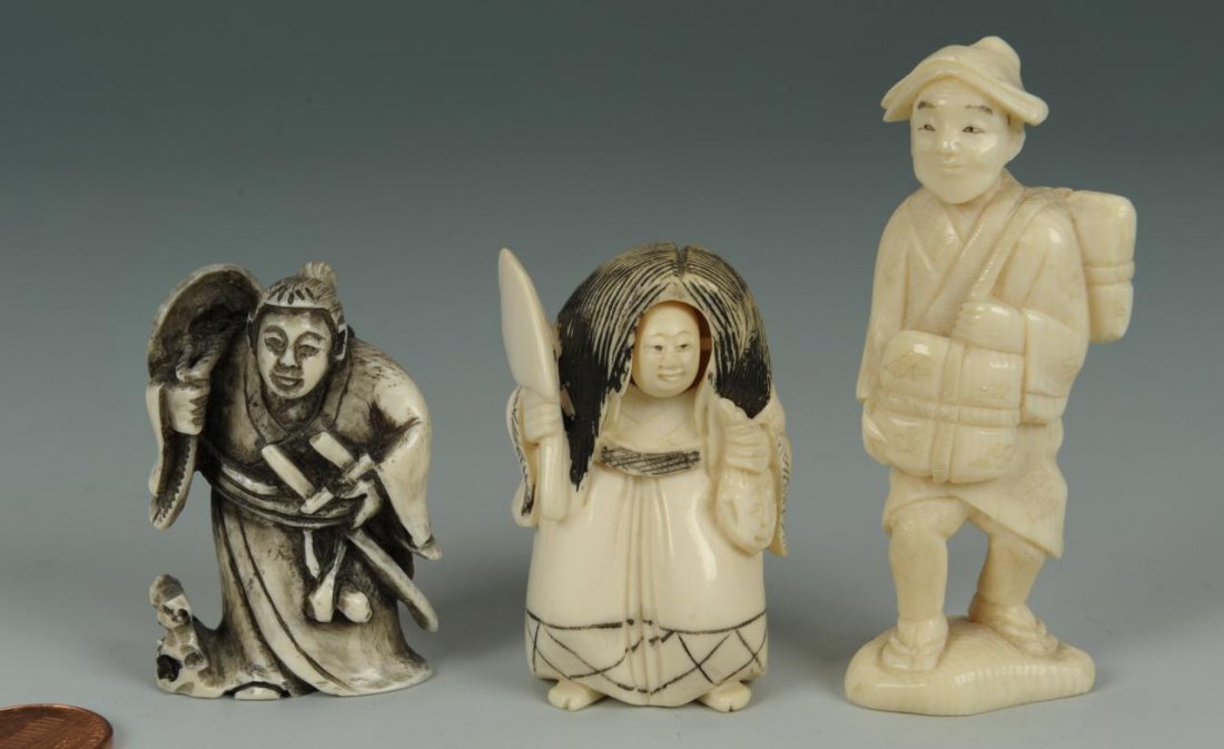 Japanese Ivory Netsukes & Okimono, 3 pcs.: Three signed Japanese ivory pieces including two netsukes and one okimono. Item 1: Carved and inked ivory kinetic netsuke figure with a movable two-sided face, holding large hatchet and decapitated he