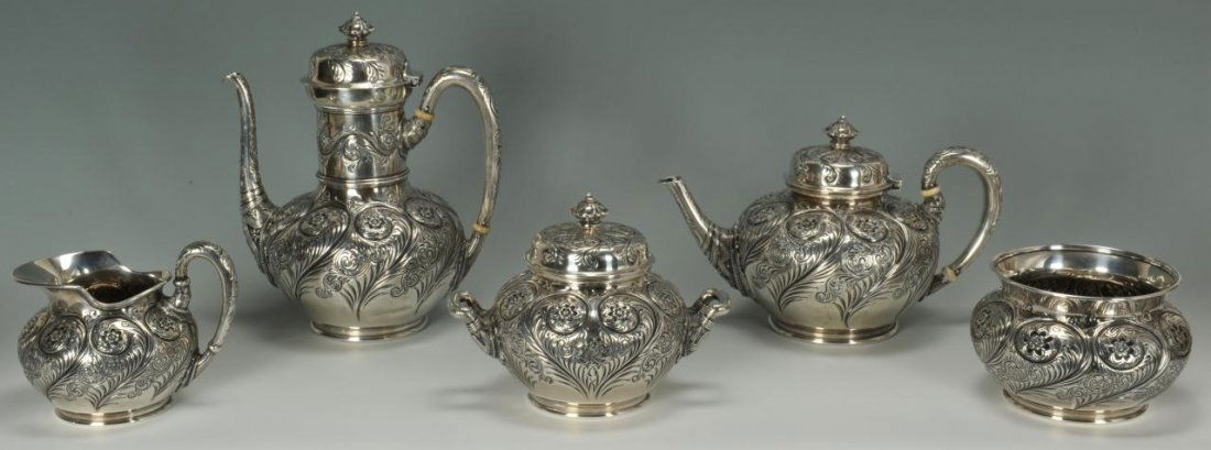 Tiffany Persian Tea and Coffee Service, 5 pcs: Five piece Tiffany & Co. sterling silver tea and coffee set in the Persian taste, featuring bodies with elaborate repousse floral and feather design, and bands of waves and beading at spouts and handl
