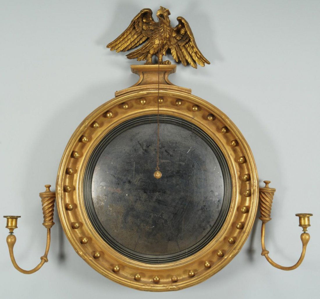 Federal Bull's Eye Mirror: Federal or Neoclassical gilt bull's eye mirror with the original glass, gilt gesso over carved wood, having an eagle with outstretched wings on crest and flanking candelabra. Backboards appear to be w