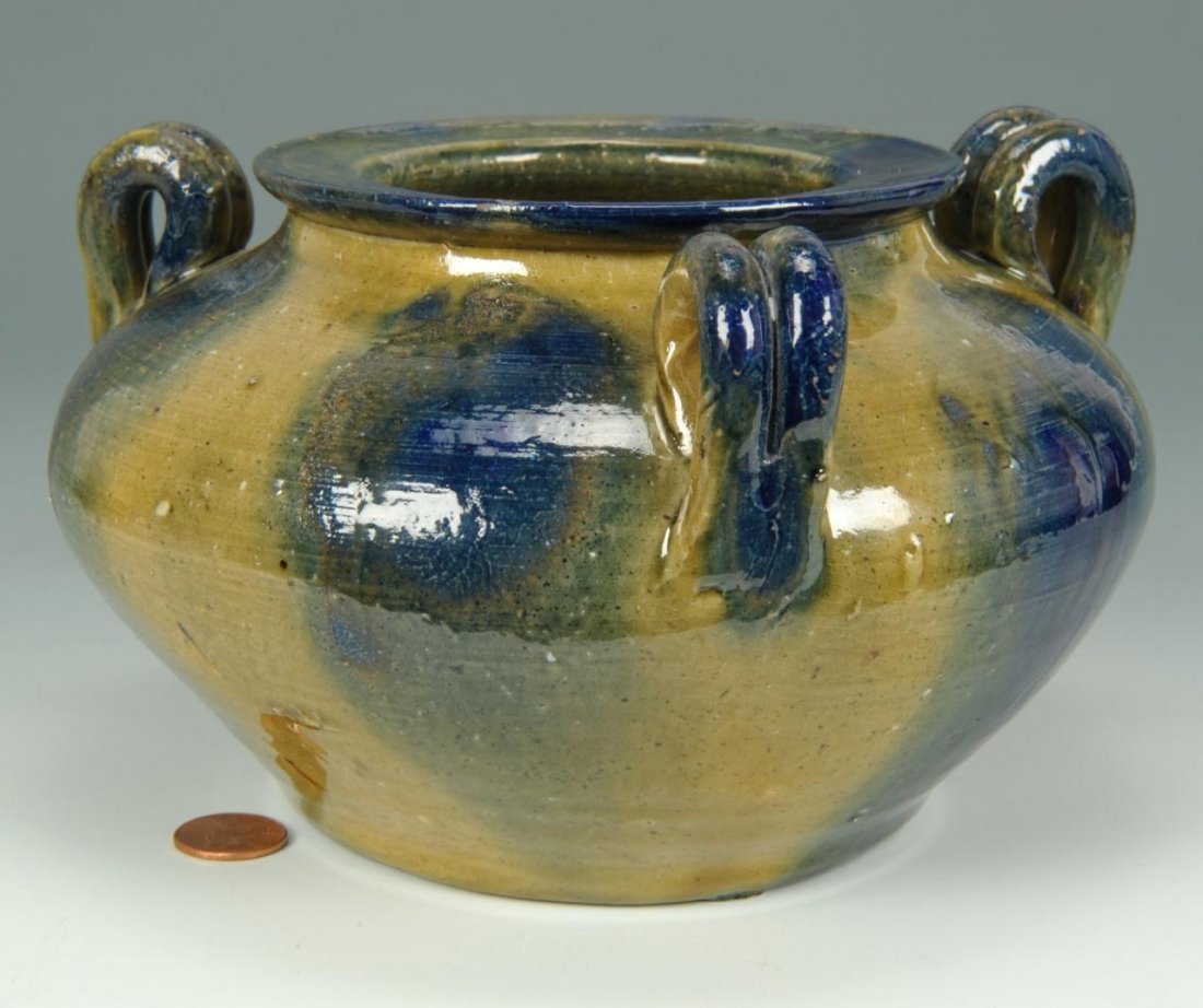 NC Auman Pottery Vase: North Carolina Auman Pottery vase, flattened rim with three looped handles and runny cobalt glaze. Unsigned, but attributed to Auman Pottery. 4-1/2" H x 8" dia. 20th century.