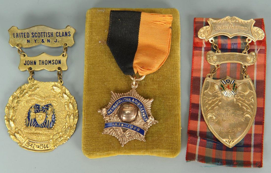 3 United Scottish Clan Medals, two (2) 10K gold: Group of 3 United Scottish Clan Medals. 1st item: 10K (marked) rose gold and blue enamel medal marked Metropolitan & Dist League 1928-1929 and engraved en verso, "John Thomson President." Manufactured
