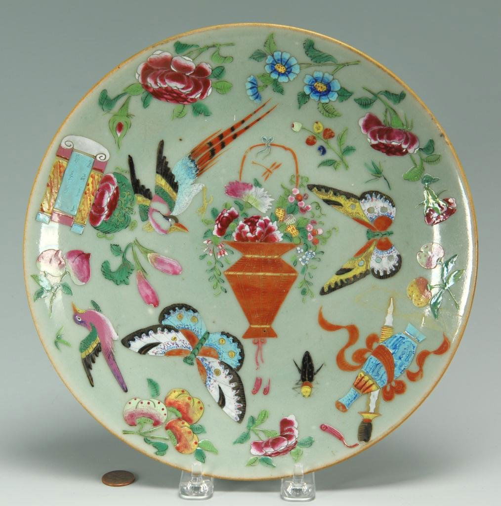 Chinese enameled celadon plate: Chinese enameled celadon plate, finely decorated in overglaze designs of birds, butterflies, prunus, fruit, insect and peonies, a basket of flowers, scroll, brush and bottle. Stylized underglaze blue