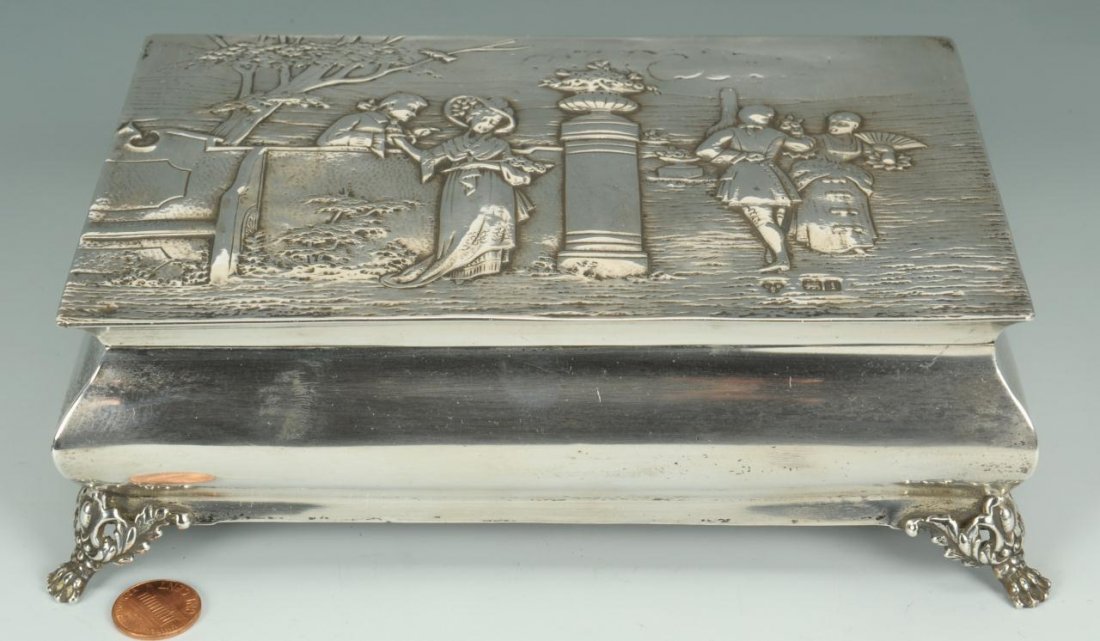English Box with Sterling Overlay: Edwardian sterling overlay box, marks for Charles, Boyton & Son, London, dated 1904. Top decorated with suitors in garden setting, resting on four paw feet. 2 6/8" H x 8 1/2" W x 5 3/4" D. Early 20th 