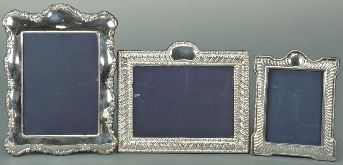 3 English Sterling Silver Photo Frames: Three English sterling silver photo frames, each hallmarked with maker's mark " E. I.". The larger frames fit 5" x 7" photos and the smaller frame fits a 3 1/2" x 5" photo. Overall measurements are 10