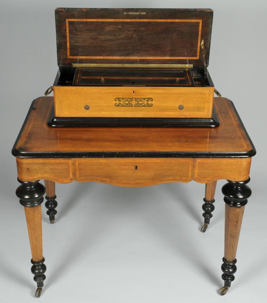 Swiss Cylinder Music Box on Stand: Swiss cylinder music box on stand, possibly Nicole Freres, with four interchangeable brass cylinders, three stored in the frieze drawer. Housed in a burl-walnut case with tulipwood banding and inlay d