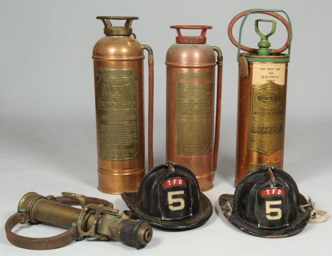 2 Firemen Helmets, Nozzle, & 3 Fire Extinguishers: Lot of several firemen related objects. Item 1: Large Wooster Brass Company two part fire nozzle with two leather handles, large valve release, and stamped Elkhorn brass on the base. 18" H x 11-1/2" W
