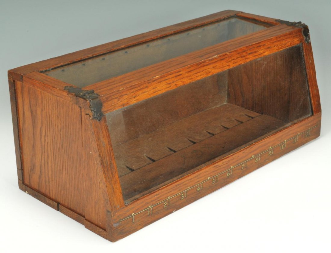 Oak countertop display case: Country store oak countertop display case with hinged, slanted glass top and glass front, notches numbered 1-12, possibly for sewing items, 6"h x 14"W x 6"D.