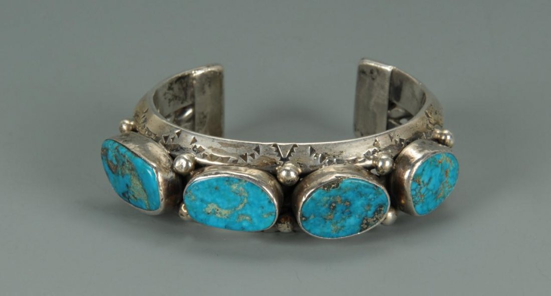 Turquoise and Silver Nugget Bracelet, Native Ameri: Native American silver cuff bracelet set with four large oval turquoise stones, hallmarked with a drawn image of a tadpole, probably Hopi or Navajo, 5/8"H, 4.05 oz troy. Purchased in the Southwest in
