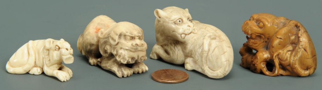 Lot of 4 Japanese Ivory Netsukes: Lot of 4 carved and inked netsukes of foo dogs, all signed on bases and one depicting a tiger, signed on the side. Ranging in height from 3/4" H to 1 1/4" H. All late 19th/ early 20th century.