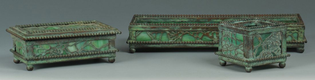 Riviere Studios Partial Desk Set, 3 items: Riviere Studios partial bronze and green slag glass desk set including a pencil/pen tray (8 1/8" L x 2 7/8" D), stamp box (4 1/2" L x 1 1/2" H) and small square box (2 7/8" x 2 1/8"). All items with i