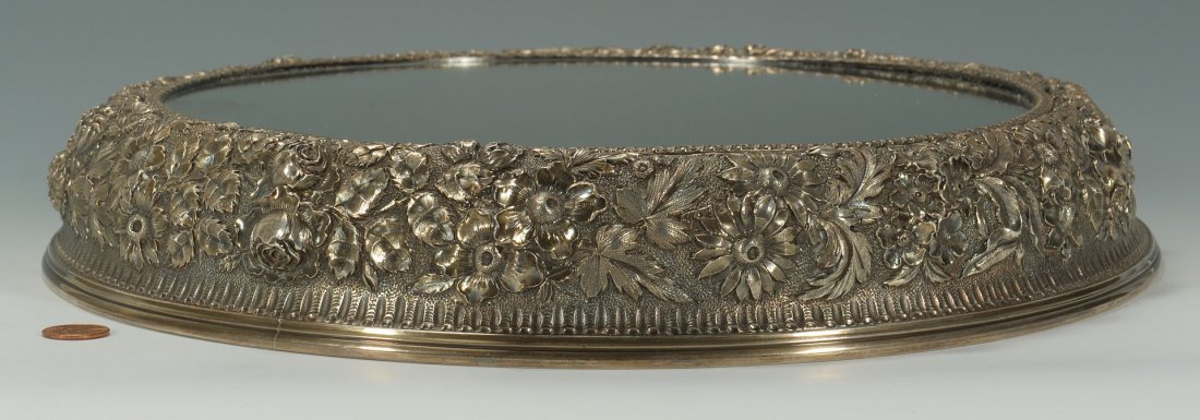 Jacobi and Jenkins Sterling Repousse Plateau: A round sterling silver plateau, decorated in an allover floral repousse design with mirrored top. Marked on underside: Sterling 925/1000 fine, Jacobi and Jenkins Makers Baltimore. 2-3/8"H, 15" diamet