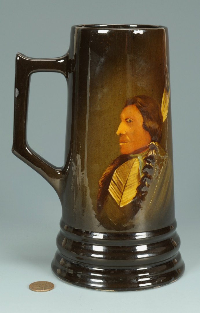 Native American Portrait Art Pottery Mug: Weller Louwelsa type mug, decorated with a portrait profile of a Native American male. Base incised with 830, B11, and initials GE. Base also marked with pencil initials C. J. O. 7 5/8" H. 1st half 20