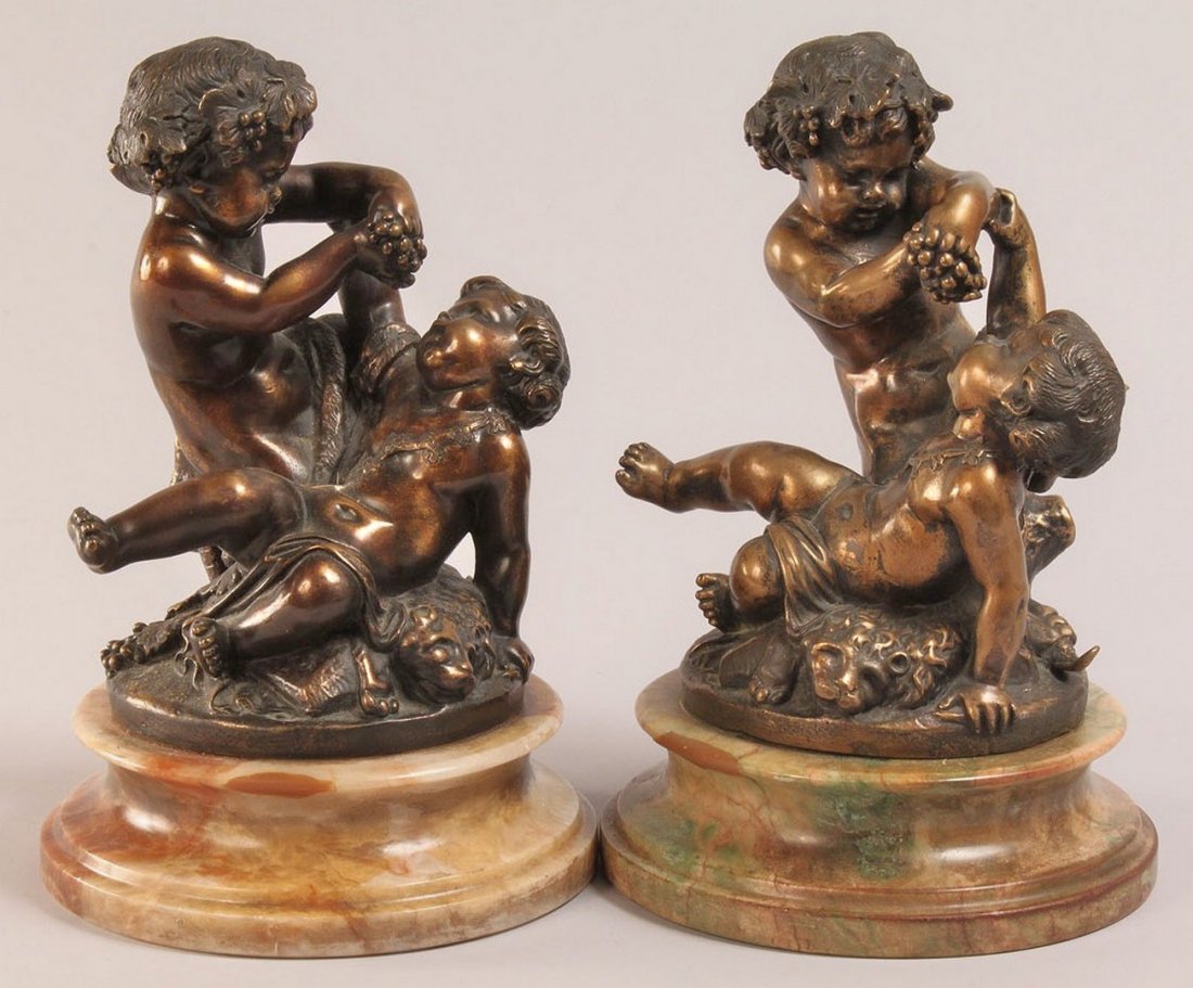 Pair of Bronze sculptures, after Clodion: Pair of bronze figures depicting Bacchus and putto atop a lion, each mounted on a marble base, after Claude Michel Clodion (French 1738-1814). Signed on base of bronze Clodion Scpt. 9-1/2" H x 6-1/4" 