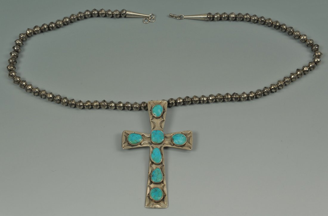 Large Navajo Sterling Necklace & Cross: Large Native American sterling necklace and cross, the necklace comprised of seventy-nine (79) sterling beads and the cross having seven (7) applied turquoise stones and etched design, signed on the b