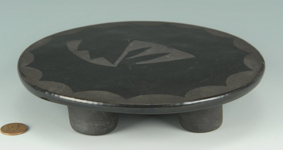 San Ildefonso blackware trivet, Blue Corn: San Ildefonso blackware trivet or stand, circular with matte scallop design at rim and central curvilinear motif. Signed on base Blue Corn/San Ildefonso Pueblo (Crucita Calabaza, 1920-1999). 1-1/2" H