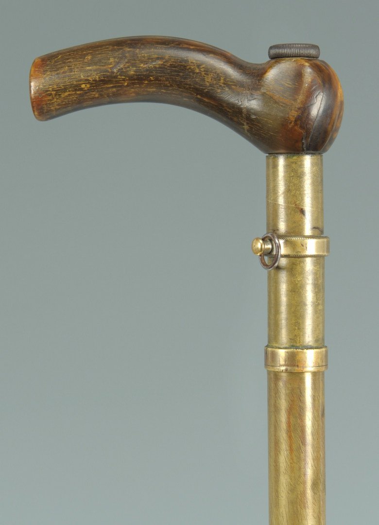 Gentleman's Dress Gun Cane: Gentleman's gun cane with wooden grip, silver plate over brass receiver, and a 29-1/2" L leather covered steel barrel with a brass end cap. It appears to be designed for a .410 caliber. Stamped 24 und