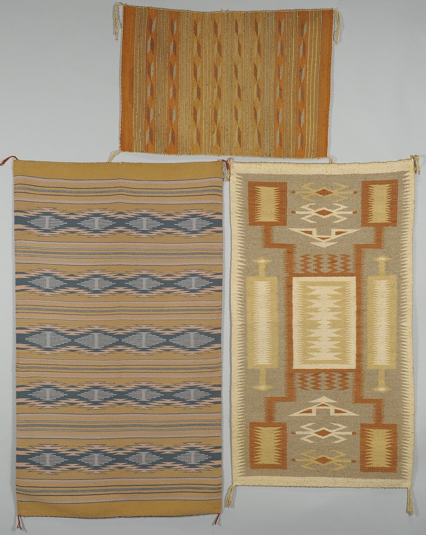 3 Navajo Rugs: Storm, Crystal, Chinle: Three Navajo rugs. 1st item: Storm area rug with grey field, cream border, secondary colors of mustard and butter yellow (55" x 31"). 2nd item: Crystal area rug with colors of blue, pink, beige and ta