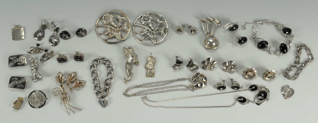 Large Group of Sterling and Costume Jewelry: Large group of sterling and costume jewelry including 2 sterling Danecraft round floral brooches and pair earrings; 1 sterling Napier art deco clip; Sterling Dutch boy pin; Sterling Van Dell black ony