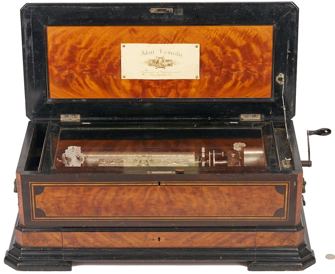 Swiss Jacot Ideal Concerta Cylinder Music Box: Swiss Jacot's Ideal Concerta interchangeable cylinder music box in satinwood case with ebonized trim and interior. Underside of lid with Ideal Concerta label. Interior fitted with hinged glass cover a