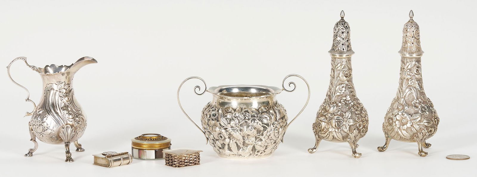 7 Items incl. Sterling Repousse Shakers, Snuff or Pill Boxes: Seven (7) small silver items. Includes a pair of two (2) A. G. Schultz & Co. sterling salt and pepper shakers in a repousse floral pattern, undersides stamped with maker's mark and S