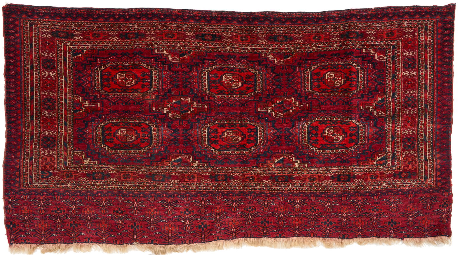 Tekke Chuval circa 1890: Antique Tekke Turkmen Chuval, wool on wool. Central dark red or rust field with two rows of three guls, and a wide lower stylized flower ensi border. Woven in rust or dark red, blue, and cream colors.