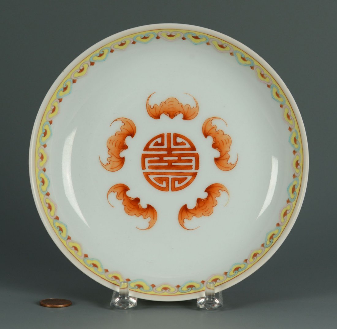 Chinese Porcelain Famille Rose Saucer Dish: Chinese porcelain Famille Rose saucer dish, the interior having five bats encircling a Shou mark, the rim with a ruyi head border and the exterior having chrysanthemums on a red ground. Based marked w