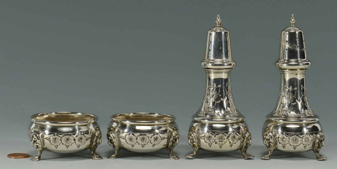 Hand chased sterling silver salts and peppers: Pair of standing salt and pepper shakers and matching open salts, all with repousse floral designs and lion masks above tripod feet, each marked on base B & M Sterling Hand Chased 51. Shakers height 5