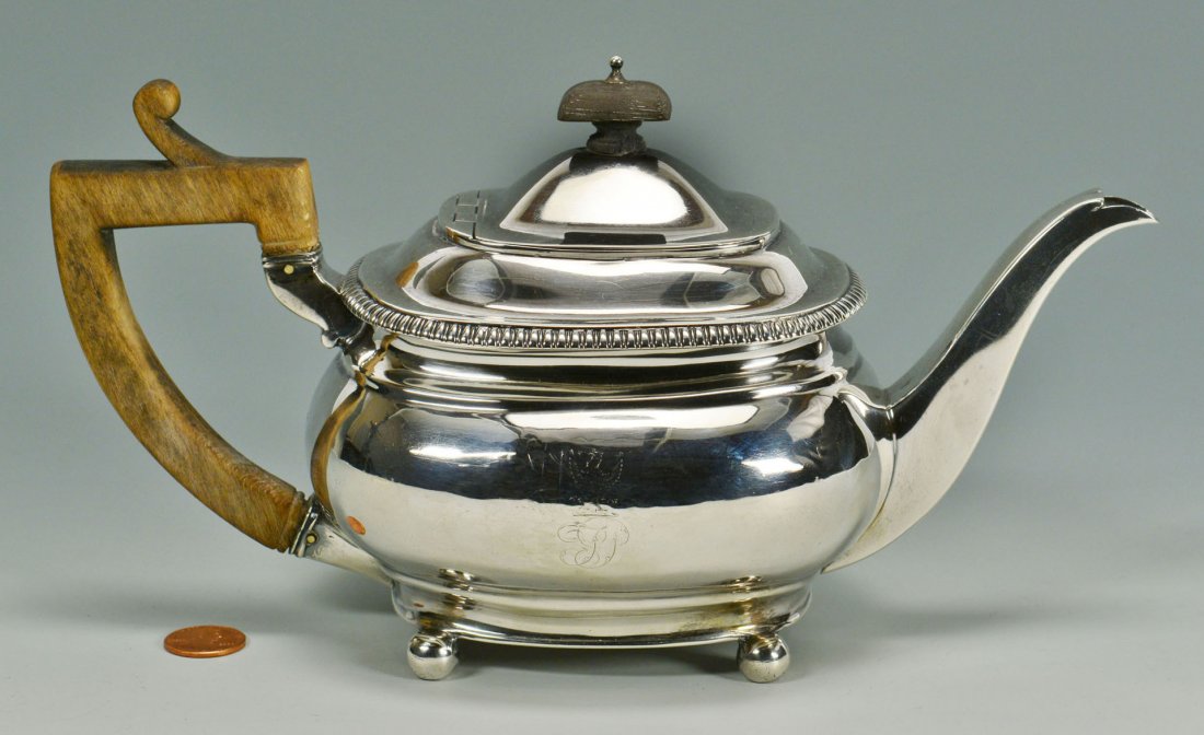 George III Sterling Silver Teapot: George III sterling silver teapot, rectangular form with ebonized finial and wood handle, gadrooned lid edge and four ball feet. Worn monogram and griffin crest on front side. Attributed to James Barr